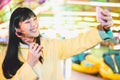 Asian girl taking selfie with mobile phone in amusement park - Happy woman having fun with new trends smartphone apps Royalty Free Stock Photo