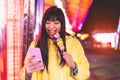 Asian girl taking selfie with mobile phone in amusement park - Happy woman having fun with new trends smartphone apps Royalty Free Stock Photo