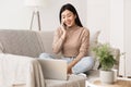 Asian Girl Talking On Phone And Surfing Internet On Laptop Royalty Free Stock Photo