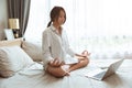 Asian Girl teen doing Yoga home practice learning online from internet trainer lesson website during Stay home self-quarantine