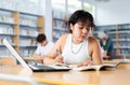 Asian girl with teenagers students studying in school library Royalty Free Stock Photo