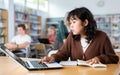 Asian girl with teenagers students studying in school library Royalty Free Stock Photo