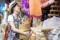 Asian girl, travel and shopping in traditional basketry shop