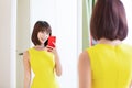 Asian girl trying dress happily Royalty Free Stock Photo