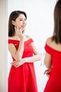 Asian girl trying dress happily Royalty Free Stock Photo