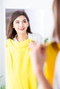 Asian girl trying dress happily Royalty Free Stock Photo