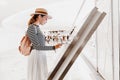 girl uses touchscreen terminal to find the right boutique in a big shopping Mall