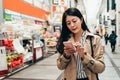 Asian girl using phone checking shopping list