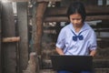 Asian girl watching at screen of laptop computer. Students in rural area study online.Concept of Happiness life style Royalty Free Stock Photo