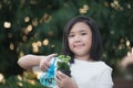 Asian girl watering a red flower in the garden Royalty Free Stock Photo