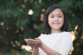 Asian girl watering a red flower in the garden Royalty Free Stock Photo