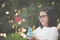 Asian girl watering a red gerbera Royalty Free Stock Photo