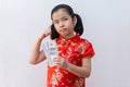 Asian girl wear cheongsam and take Red envelopes and thinking in chinese new year Royalty Free Stock Photo