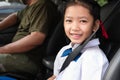 Asian girl wear uniform sit in the car
