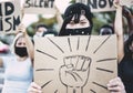 Asian girl wearing face mask while protest against racism on city street - Equal rights and demenstration concept - Focus on eyes