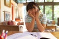 Asian girl wearing phone headset smiling during video call, learning online Royalty Free Stock Photo