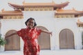 Asian girl wearing red chinese suit happiness against china temple background