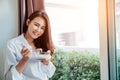Asian girl who just wake up in the morning as relaxed. Royalty Free Stock Photo