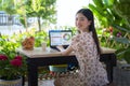 Asian girl working at home by note book computer in garden Royalty Free Stock Photo