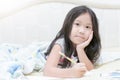 Asian girl writing to diary on the bed Royalty Free Stock Photo