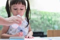 Asian girl, 3-year-old is drinking milk from a bottle Royalty Free Stock Photo