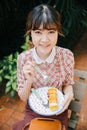 Asian Girl young teen hipster happy eating dessert cake roll