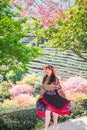 Asian girls in the cherry blossom bushes in spring