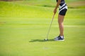 Girls are playing golf on a sunny day on the beautiful green golf course. Royalty Free Stock Photo