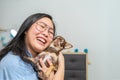 An Asian Glasses girl hugs her brown Chi Hua Hua dog, it feels the love of her also Royalty Free Stock Photo