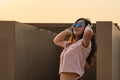 Asian glasses long hair girl is dancing on the rooftop of the building in twilight sunset time Royalty Free Stock Photo