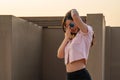 Asian glasses long hair girl is dancing on the rooftop of the building in twilight sunset time Royalty Free Stock Photo