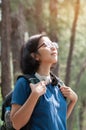 Asian glasses woman hiker with backpack breathing nature fresh a