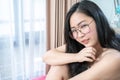 Asian Glasses Woman relax on her bed in the morning at her bedroom