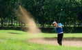 Asian golfers hit the ball in the sand. Speed and Strength