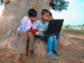 asian government school kids learning about laptop computer system at natural background in india January 2020