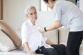 Asian granddaughter taking care of helping senior grandmother get dress,button up shirt for the elderly Alzheimer`s,chang clothes Royalty Free Stock Photo