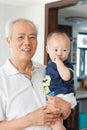 Asian grandfather holding grandson