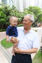 Asian grandfather holding grandson