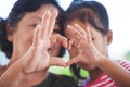 Asian grandmother and little child girl making heart shape with hands together Royalty Free Stock Photo