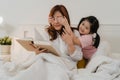 Asian grandmother relax at home. Senior Chinese, grandma happy relax with young granddaughter girl enjoy close her eyes surprise Royalty Free Stock Photo