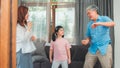 Asian grandparents and granddaughter listen to music and dance together at home. Senior Chinese, grandpa and grandma happy spend