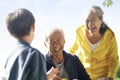 Asian grandparents and grandson enjoying nature in park