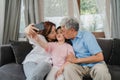 Asian grandparents selfie with granddaughter at home. Senior Chinese, grandpa and grandma happy spend family time relax using