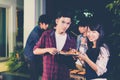 Asian group of friends having outdoor garden barbecue laughing with alcoholic beer drinks on night Royalty Free Stock Photo