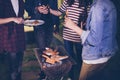 Asian group of friends having outdoor garden barbecue laughing w Royalty Free Stock Photo