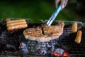 Asian group of friends having outdoor garden barbecue laughing w Royalty Free Stock Photo