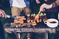 Asian group of friends having outdoor garden barbecue laughing w Royalty Free Stock Photo