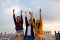 Asian group of friends lighting sparklers and enjoying freedom at sunset,asian woman holding sparklers happily on rooftop Royalty Free Stock Photo