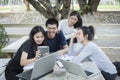 Asian Group of students using tablet and notebook sharing with t Royalty Free Stock Photo