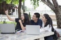 Asian Group of students using tablet and notebook sharing with t Royalty Free Stock Photo